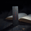 Elegant thriller-themed bookmark standing beside an open mystery novel, with dark moody tones and cinematic lighting — perfect for psychological thriller book lovers.